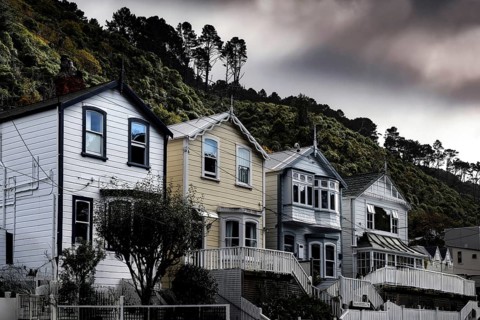 Wooden houses on a hill against cloudy sky in Wellington, Wellington, New Zealand