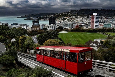 Red cable car overlooks Wellington and its green hills as well as the city, Wellington, New Zealand