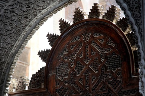 Traditional wooden door with complex Islamic decorations in Medersa Attarine, Fez, Fès-Boulemane,