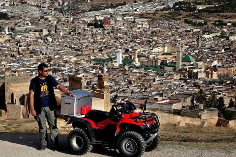 Man with quad bike in view of Fez from the Merinid Tombs, Fez, Fez el Bali, Morocco