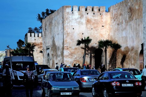 City scene with massive walls and busy car traffic in the foreground, Meknès, Fès-Meknes, Morocco