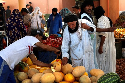 People buy melons on vegetable souk in Guelmim, Guelmim, Guelmim-Oued Noun, Morocco
