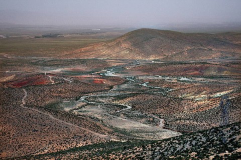 Wide, dry landscape with rolling hills and meandering river, Midelt, Morocco