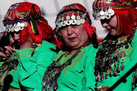 Traditional Berber dancers in colorful clothes at the Fête des Roses, El Kelâa m'Gouna, Morocco