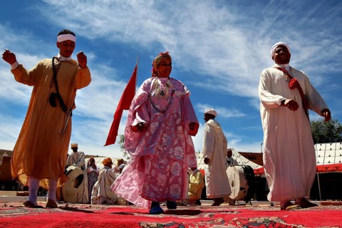 Scene of men wearing traditional Berber clothes during a celebratory dance performance, El Kelâa