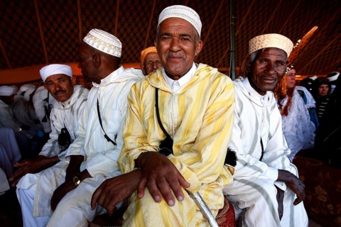 Men in traditional clothing in the participant tent during the Fête des Roses, El Kelâa m'Gouna,