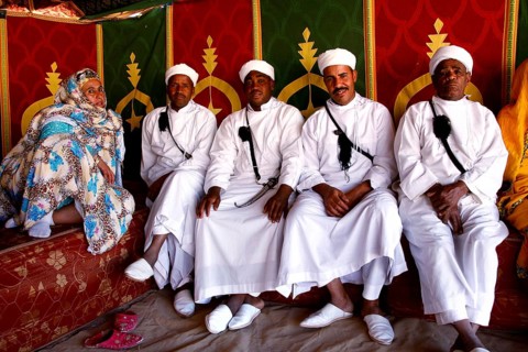 Participants wearing traditional Berber clothing during the Fête des Roses in the participant tent,