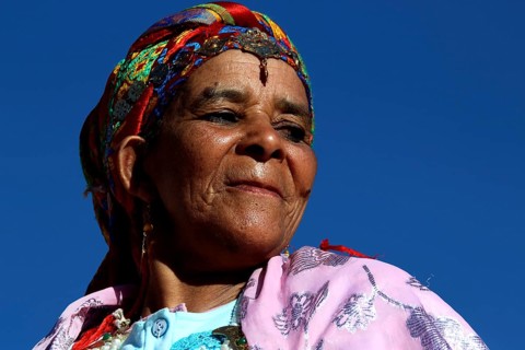 Woman wearing colorful traditional clothing and headdress at the Rose Festival in El Kelâa m'Gouna,