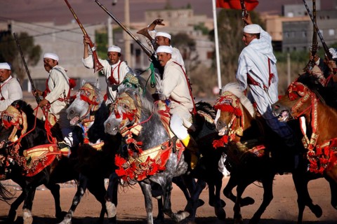 Equestrian group in traditional Moroccan costumes presents military choreographies on horses, El