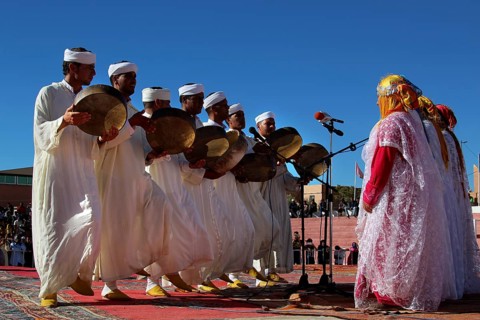 Berber dancers in traditional white clothes dance at the Festival of Roses, Ma El Kelâa m'Gouna,