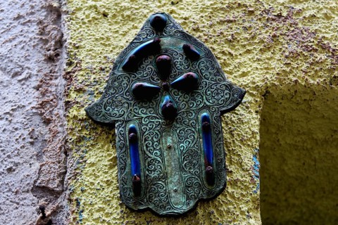 Hamsa hand relief as a decorative element on a wall in Essaouira, Essaouira, Morocco