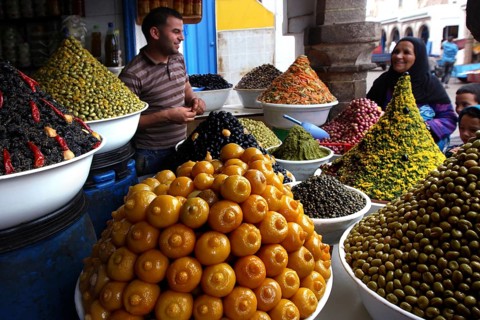 Dealer offers various pickled olives and lemons in the Essaouira souk, Essaouira, Morocco