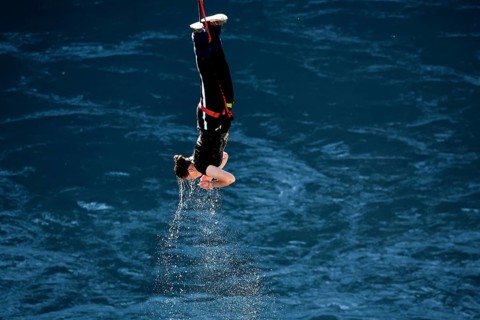 Jumpers diving headfirst into water from lofty heights, Queenstown, Otago, New Zealand