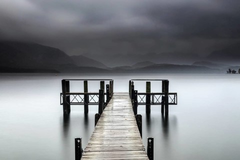 Wooden walkway leads into foggy Lake Te Anau, surrounded by mystical atmosphere, Te Anau,