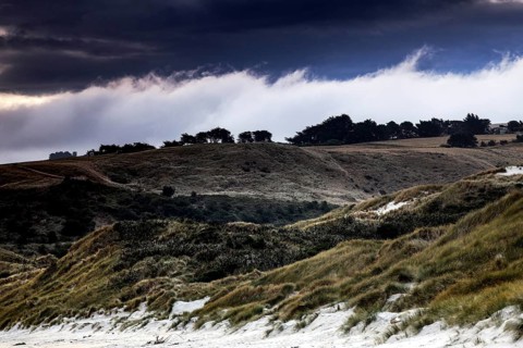 Wide dune landscape in Sandfly Bay with dramatic skies on the Otago Peninsula, Sandfly Bay, New