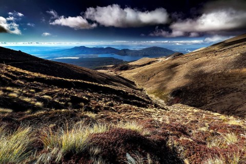 Wide ranges of hills open with views of Lake Taupo under dramatic clouds, Tongariro National Park,