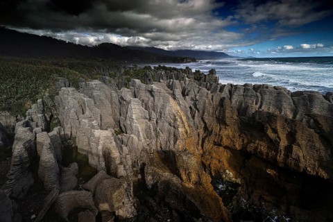 Dramatic coastal landscape with bizarre rock formations on the stormy sea