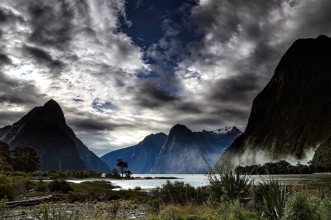 Impressive fjord with dramatic skies and majestic high mountains, Milford Sound, New Zealand