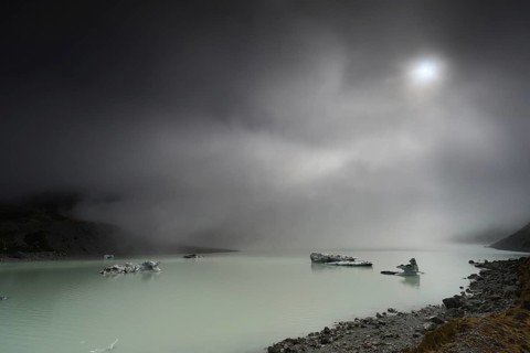 Night view of a glacial lake under cloudy sky in Aoraki National Park, Mt Cook, Hocker Valley
