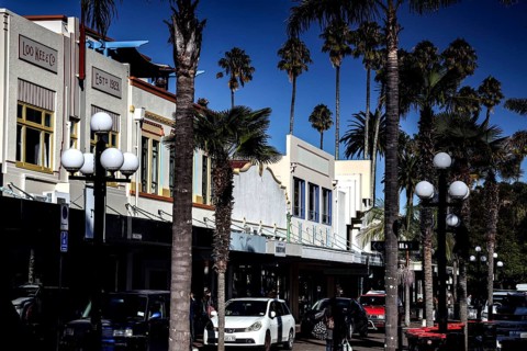 Street scene with art deco buildings and palm trees on a sunny day, Napier, Hawke's Bay, New