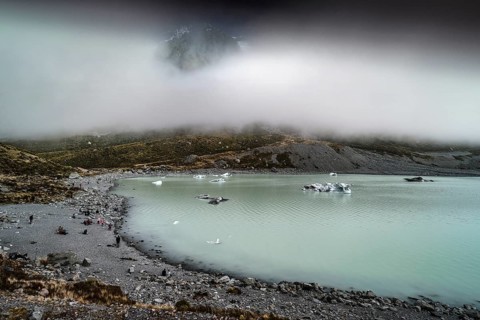 Glacial lake in misty Aoraki Mt Cook National Park with rugged shores, Mt Cook, Hocker Valley