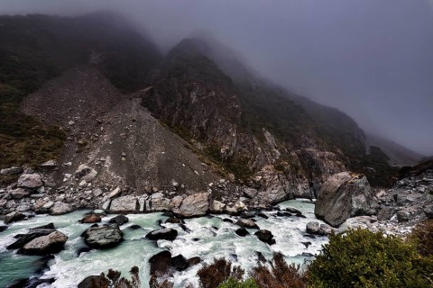 Rocky mountain landscape in fog with wild river in Hocker Valley, New Zealand, zero
