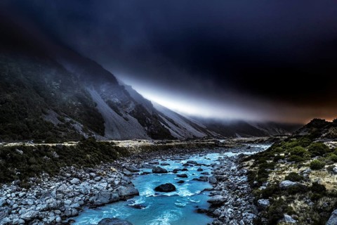 River and rocky landscape under an ominous sky in Hocker Valley, New Zealand, zero