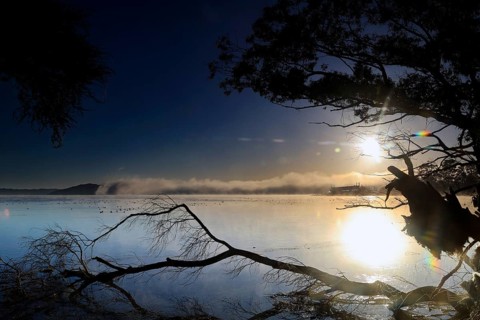 Sunrise over Lake Rotorua with dramatic reflections, Rotorua, Bay of Plenty, New Zealand