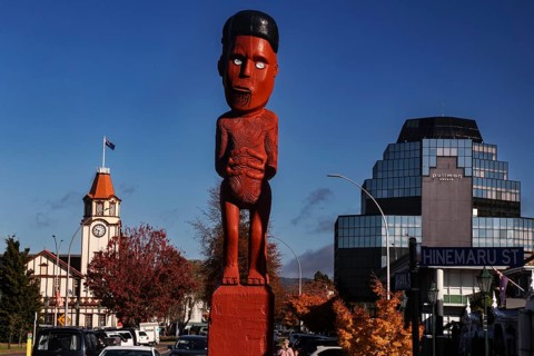 Maori figure and clock tower in Arawa Street, Rotorua, Rotorua, Bay of Plenty, New Zealand