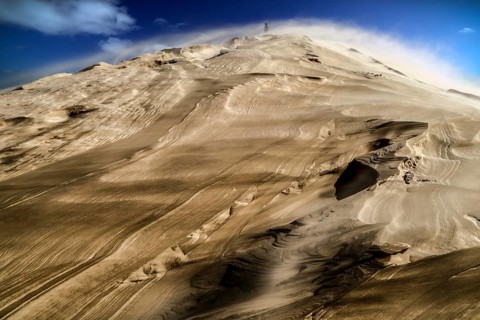 Dramatic Te Paki sand dune in sandstorm under blue sky, Ninety Mile Beach, Te Paki, New Zealand