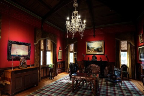 Sumptuous room in the castle with antique furniture and a large chandelier, Larnach Castle, Otago