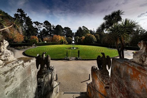Round garden area in front of Larnach Castle, surrounded by trees and sculptures, Otago Peninsula,