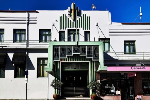 Art Deco building with distinctive green entrance under blue sky, Napier, Hawke's Bay, New Zealand