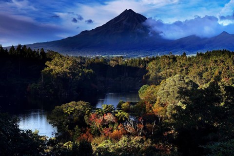 Mount Taranaki above Lake Mangamahoe, surrounded by lush green nature, New Zealand, zero