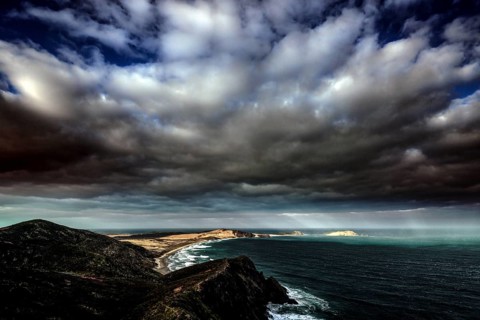 Dramatic sky over Cape Reinga and the New Zealand coastline, Cape Reinga, Ninety Miles Beach, New