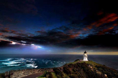 Confluence of Tasman Sea and Pacific at Cape Reinga with lighthouse and color sky, Cape Reinga,