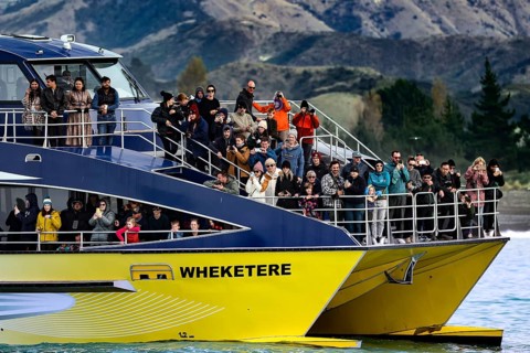 Tourists watch marine life off Kaikoura, Kaikoura, New Zealand on a boat