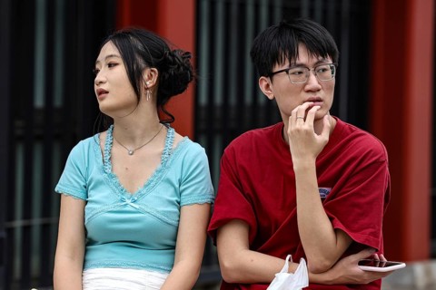A couple sits thoughtfully on a bench in Asakusa, Tokyo, Tokyo, Asakusa, Japan