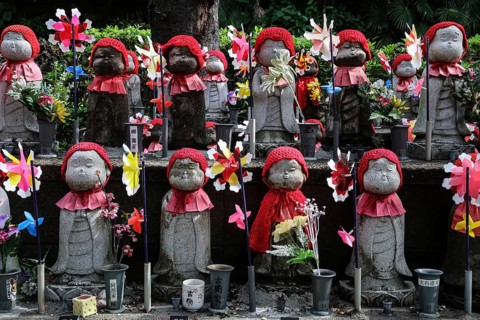 Many jizo statues with red cloths and wind turbines at Zojo-ji Shrine in Minato, Tokyo, Tokyo,