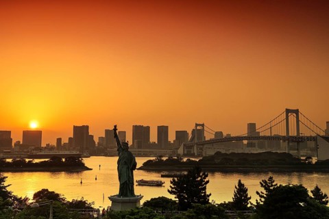 Statue of Liberty and Rainbow Bridge in the background of a sunset, Tokyo, Japan