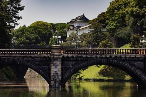 The Nijubashi Bridge in front of the Imperial Palace surrounded by lush greenery, Tokyo, Japan