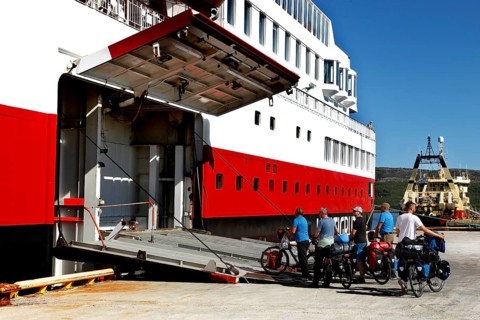 Cyclists enter the Hurtigruten ship via the tailgate in Kirkenes, Kirkenes, Finnmark, Norway