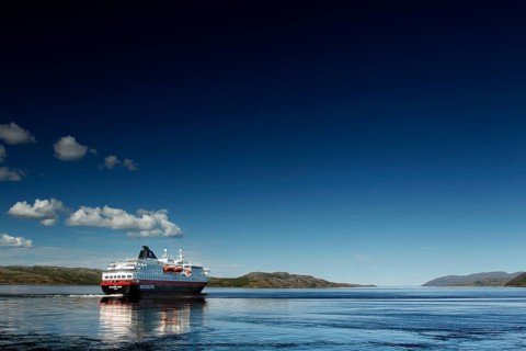 Hurtigruten ship on calm sea with bright sky, Kirkenes, Finnmark, Norway