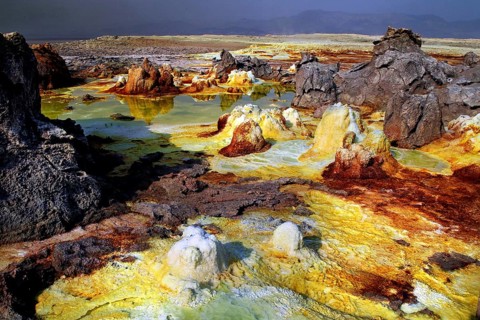 Dynamic volcanic landscape in Dallol with orange and black rocks, Dallol, Afar region, Ethiopia