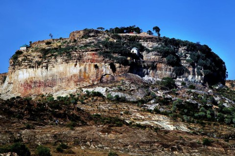 A monastery perched on a wooded plateau under clear skies, Debre Damo, Tigray, Ethiopia