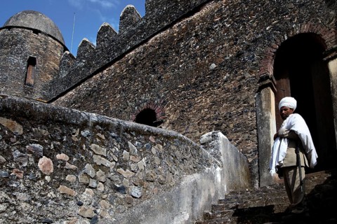 Castle stone staircase with traditionally dressed person at the entrance in Gondar, Gondar, Amhara,
