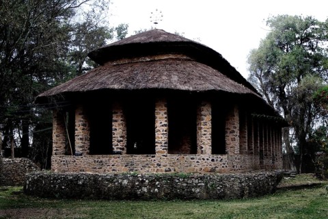 Stone church with round roof and columns in Debre Berhan Selassie