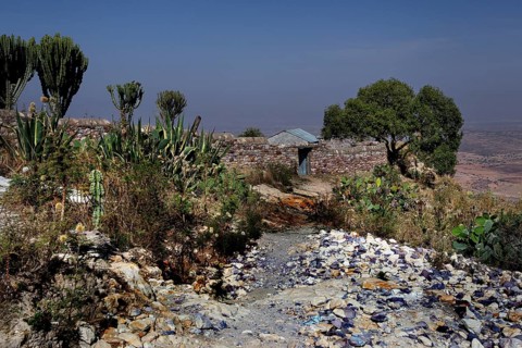 Surrounding the Debre Mariam Krokor monastery with lush vegetation and rocky landscape, zero