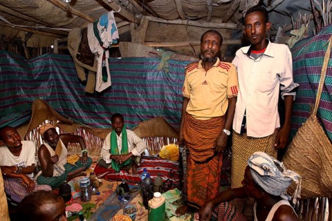Tribal leaders attend a meeting in a clothed room