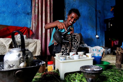 Woman serves coffee in traditional ceremony in Lalibela, Lalibela, zero